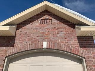 Brick gable over a garage with decorative arch masonry