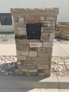 Stone mailbox pillar with block and cap detailing