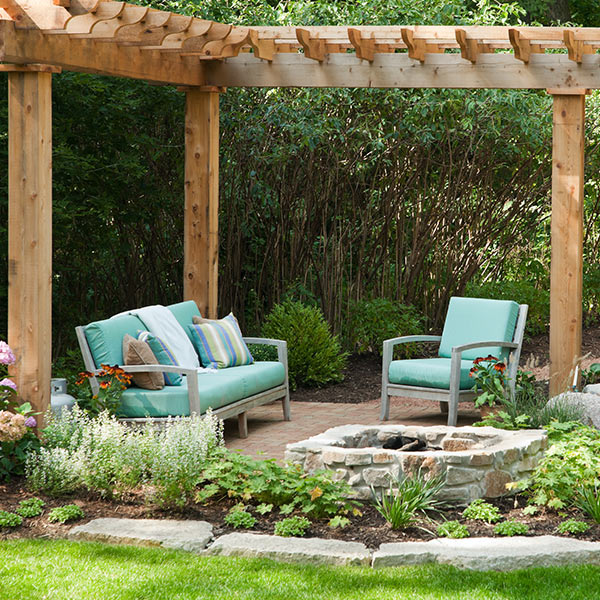 patio area with stone fireplace and furniture